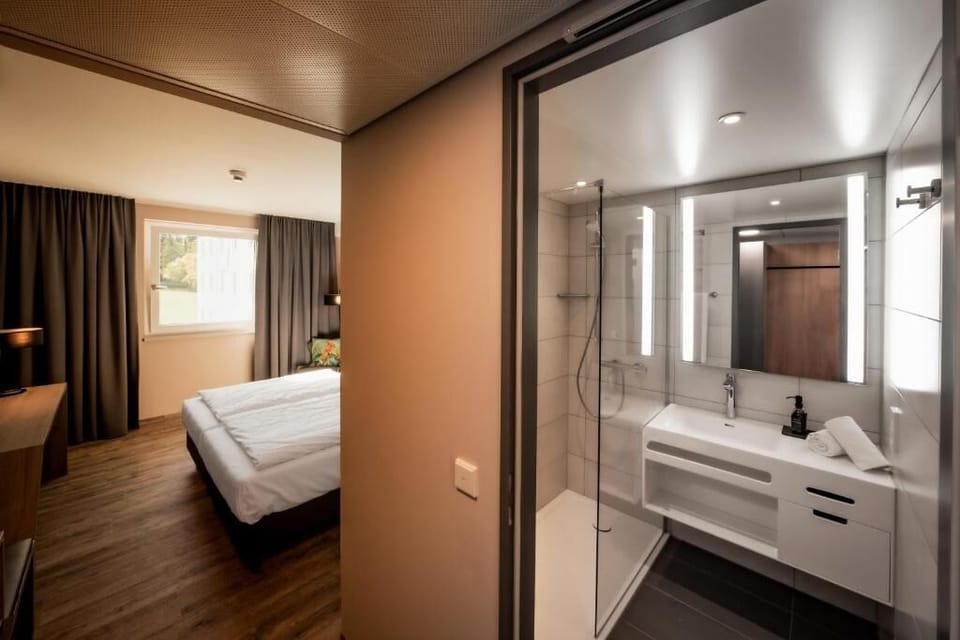 Refresh easily with a sleek vanity and glass-walled shower.