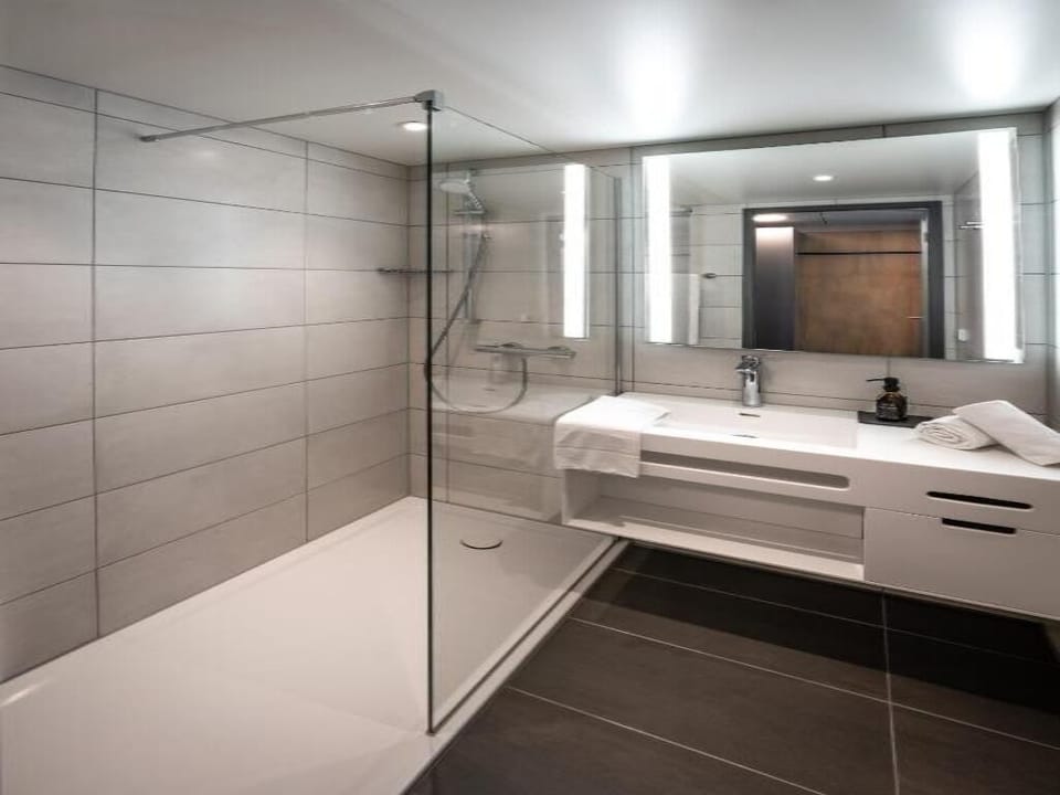 Start your day in a bright, modern bathroom with rainfall shower.