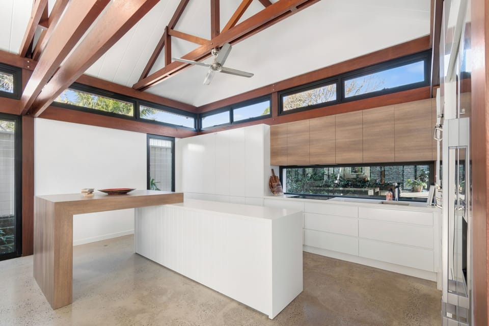 Cook and connect around the central island, with sleek cabinetry, generous prep space and open sightlines back to the living and dining zones.
