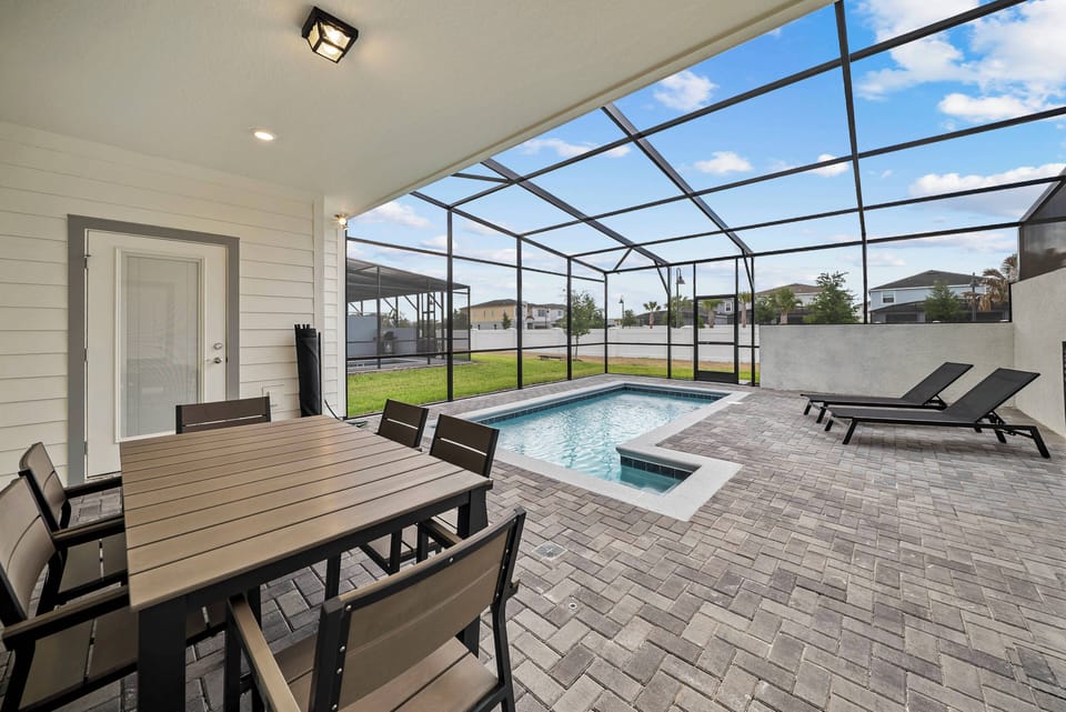 Step outside to your private oasis, complete with a spacious dining area and a sparkling pool surrounded by screened walls. Enjoy a perfect blend of relaxation and entertainment in the warm sunshine.
