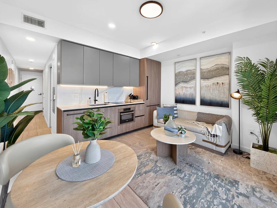 Bright and cozy living area with smart TV and comfy seating.