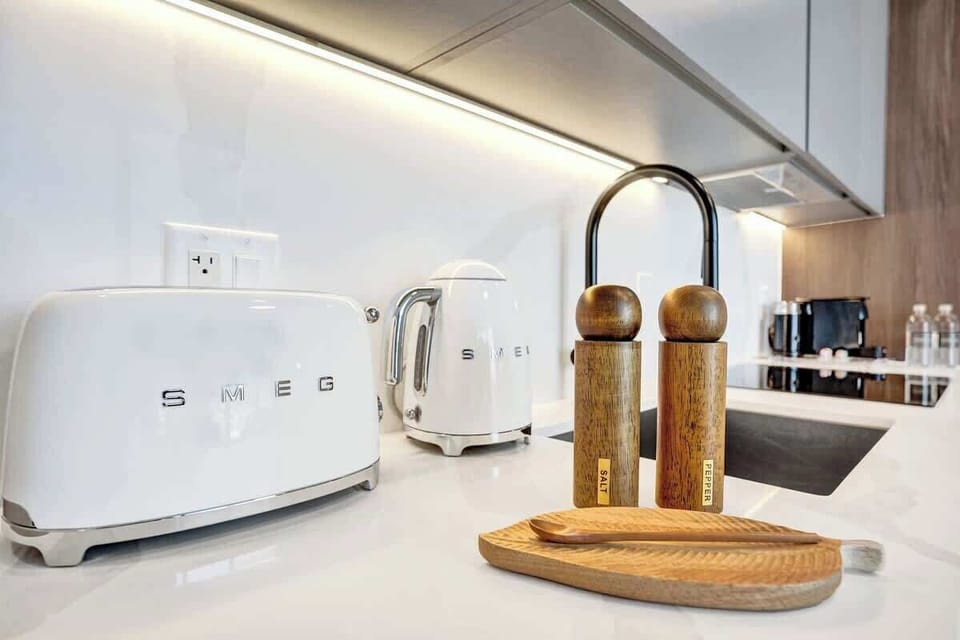 Fully equipped kitchenette with modern appliances, coffee machine, and essentials for easy meals.