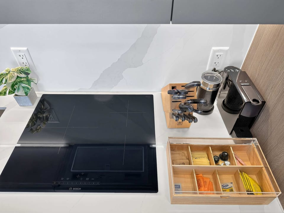 Fully equipped kitchenette with modern appliances, coffee machine, and essentials for easy meals.