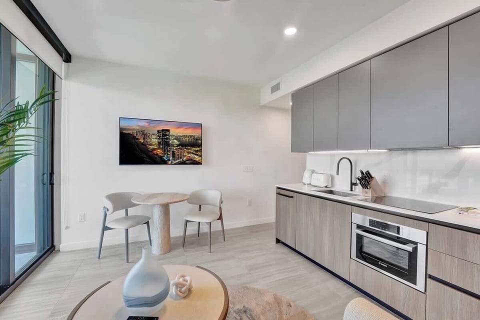 Fully equipped kitchenette with modern appliances, coffee machine, and essentials for easy meals.