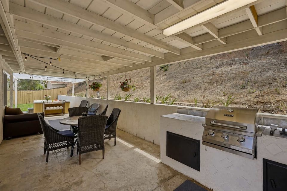 🔥 Grill, dine and relax without leaving the shade—the covered patio's full setup in one wide view.
