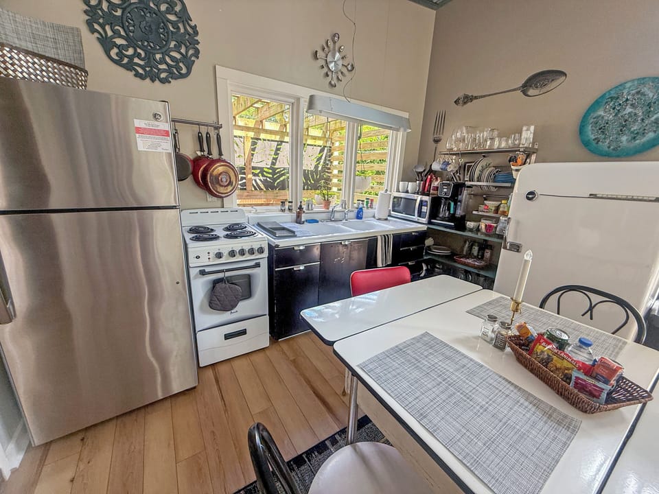 Bright vintage-style kitchen with dining nook and garden-view windows