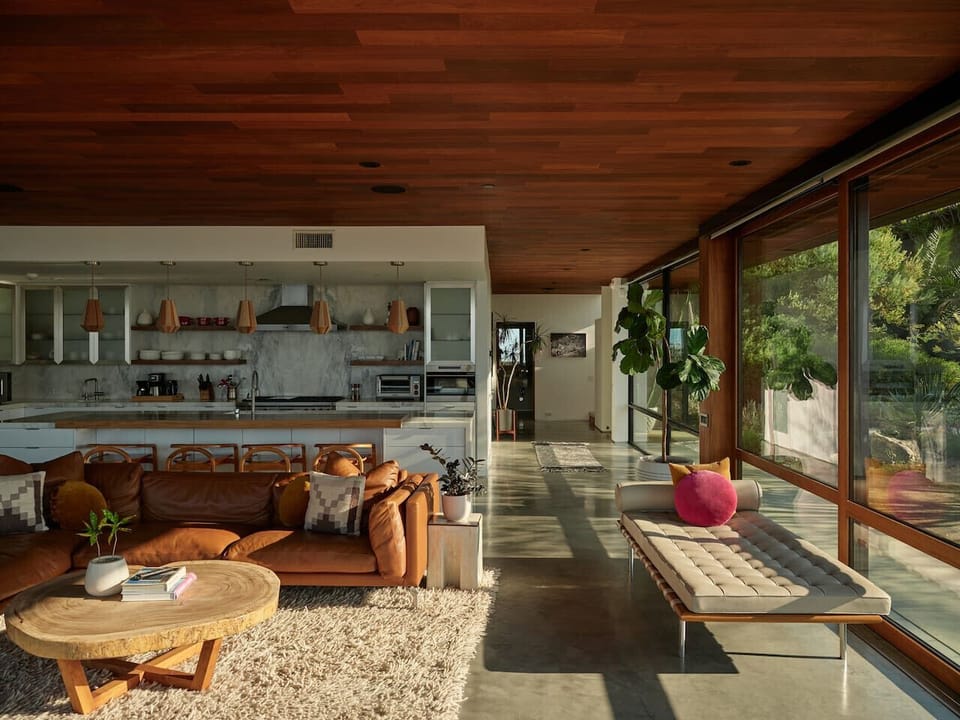 When golden hour hits the open plan. Leather, wood, marble, and warm California light.