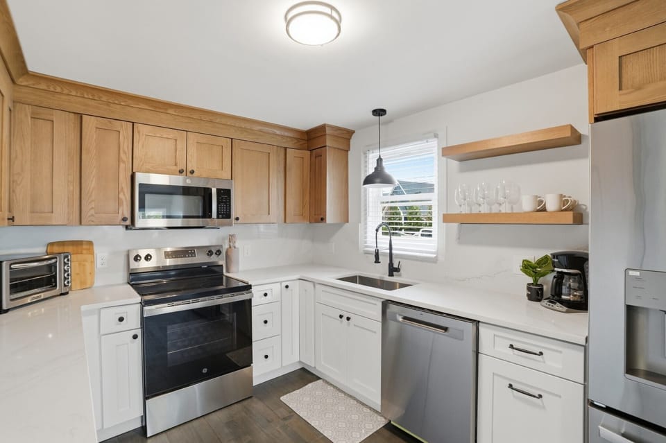Fully equipped chef’s kitchen featuring a dishwasher, drip coffee station, and a versatile air fryer for easy meal prep—everything you need for a home-cooked coastal feast.