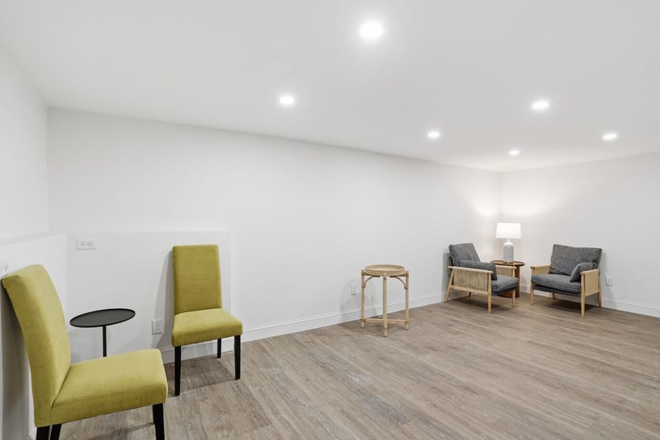Large lower-level living area with additional seating and access to the dedicated laundry room for your convenience.