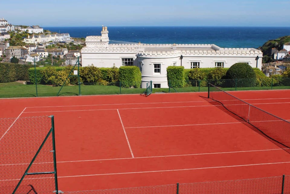 Private tennis court with stunning sea views and surrounding countryside scenery