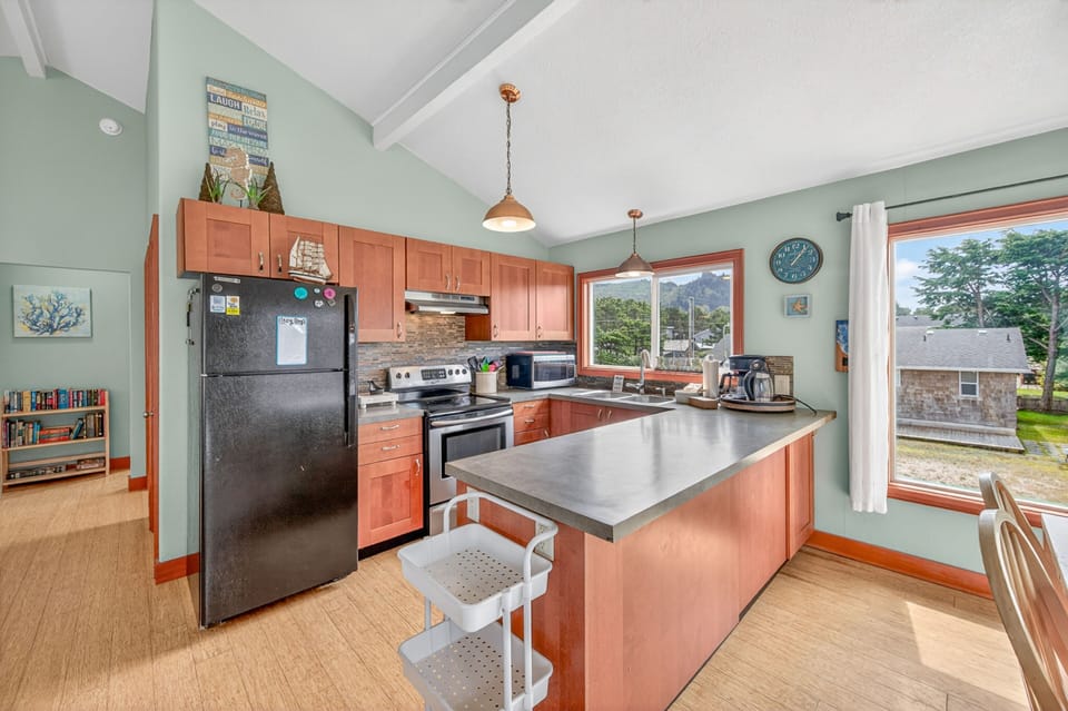 Your well-equipped kitchen awaits with warm wood cabinets, modern appliances, and generous counter space for preparing meals together.