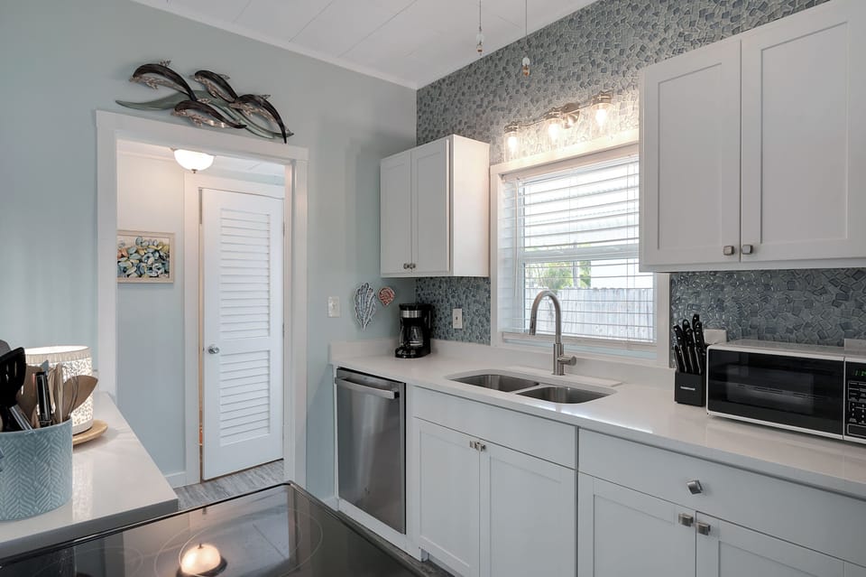 Beautiful glass tile backsplash finishes off the kitchen