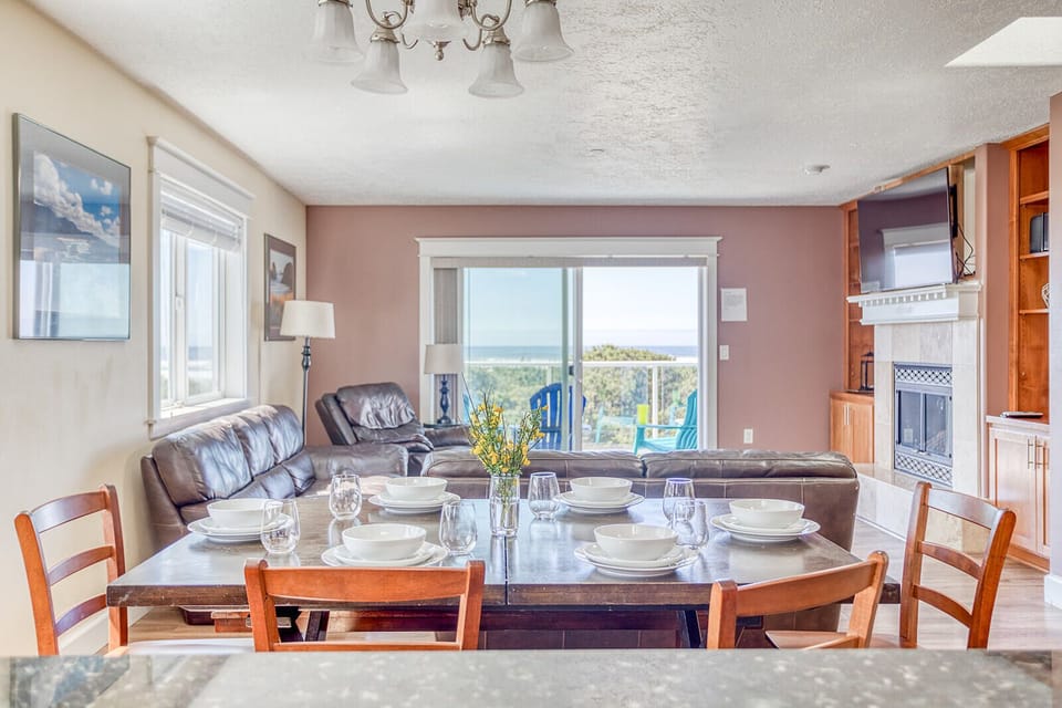 Gather around your elegant dining table for memorable meals while natural light streams through windows overlooking scenic views beyond.