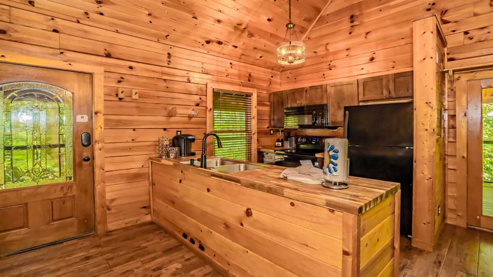 Cook with ease in the fully stocked kitchen, featuring ample counter space for prepping, serving, and gathering.
