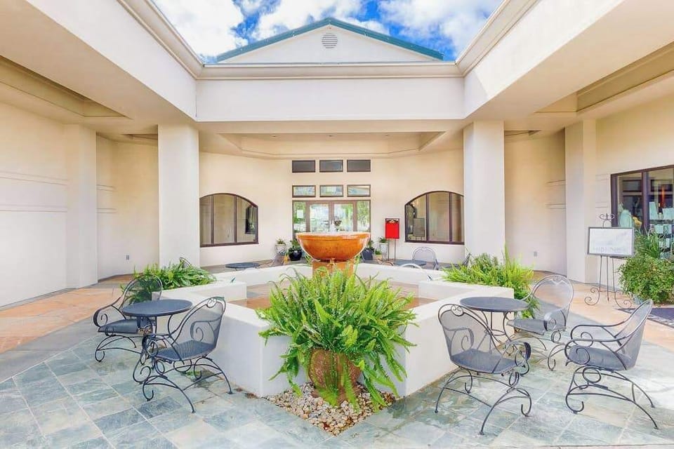 Gather around the elegant courtyard fountain at Silverado Resort — wrought iron café seating and open-air columns set the scene for your Napa escape.
