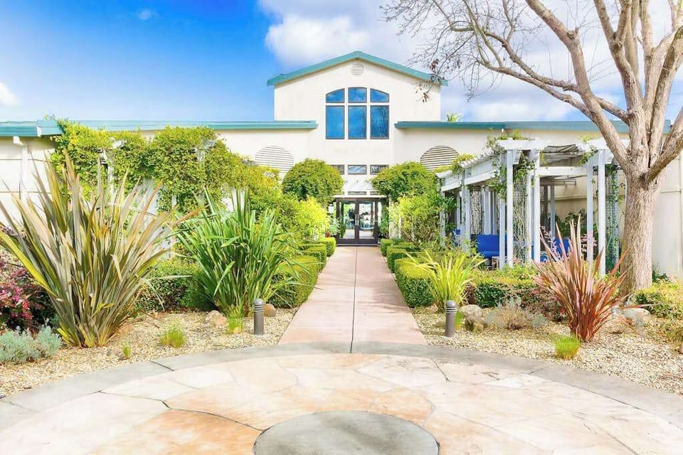 Follow the garden walkway to Silverado's spa and clubhouse — lush plantings and striking architecture set the mood for your Napa Valley wellness retreat.