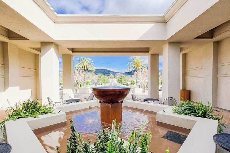 Indulge in resort-level relaxation at the Silverado Spa, where a tranquil fountain courtyard frames stunning Napa Valley mountain views.