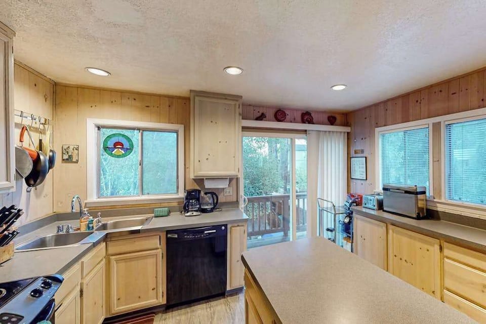 Brew your first cup while morning light streams through the windows — a fully equipped kitchen with dishwasher, gas range, and coffee maker awaits.