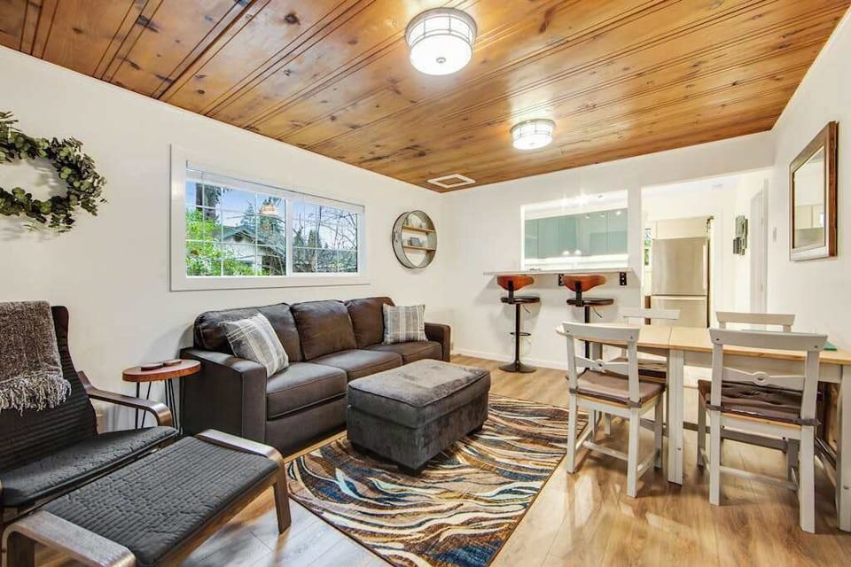 Morning sunlight streams through the windows as you plan your day of winery visits from this inviting living space with warm honey-toned floors and ceilings.