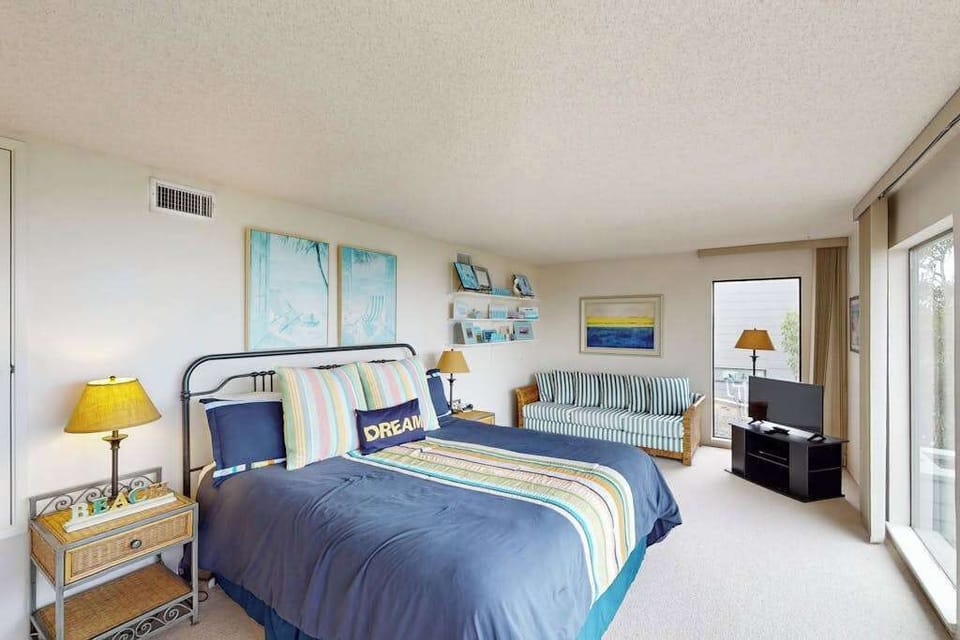 Dream big in this cheerful king bedroom with a cozy reading nook, ocean-blue accents, and coastal artwork framing your Bodega Bay retreat