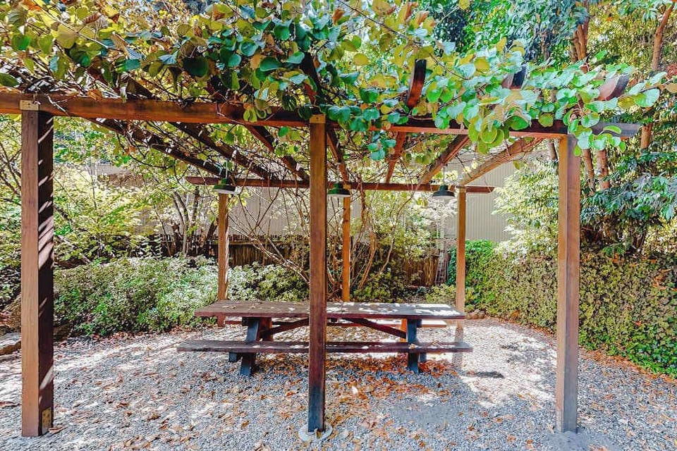 Dine al fresco beneath a vine-draped pergola — your private garden picnic spot is ideal for morning coffee or an evening cheese board.