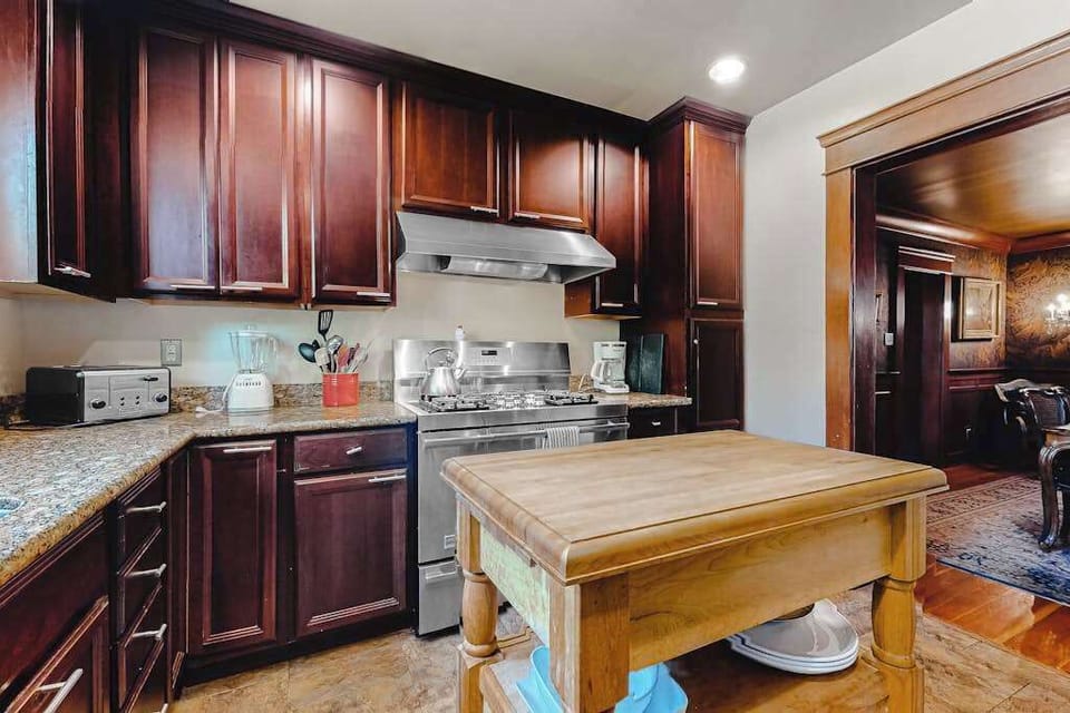 Cook your farmers-market finds in a fully equipped chef's kitchen — cherry cabinetry, granite counters, and a butcher-block island at your fingertips.