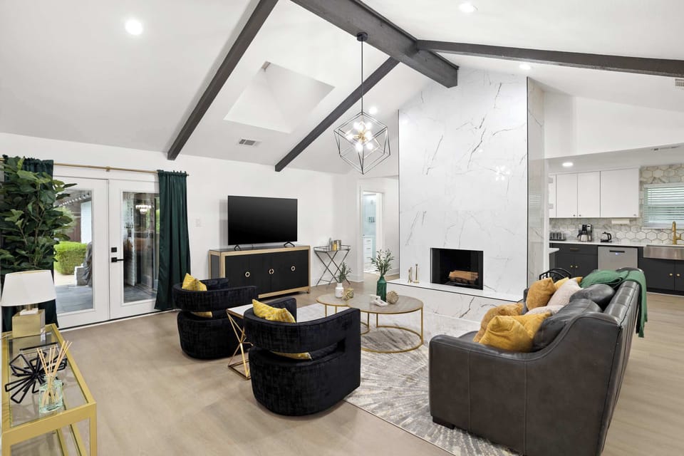 Bright, open-concept living with vaulted ceilings, designer finishes, and a sleek fireplace—perfect for relaxing in style.