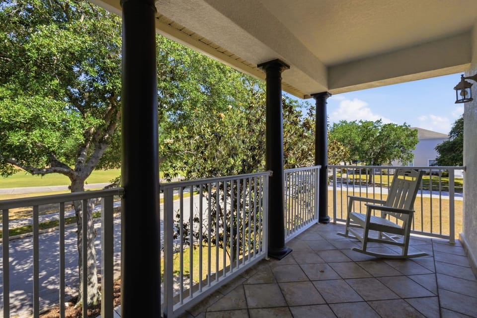 Private balcony access with rocking chair seating—perfect for morning coffee or evening wind-down.