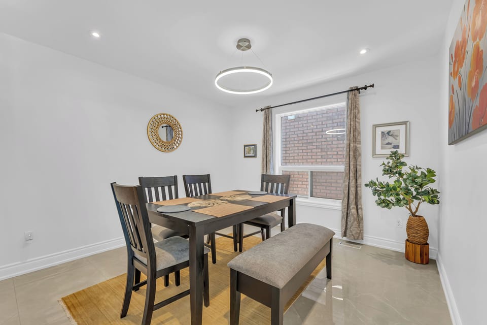 Stylish dining set situated in an open-concept, sunlit space.