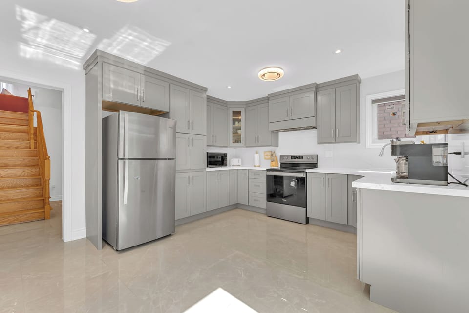 Full kitchen equipped with stainless steel appliances and cabinetry.