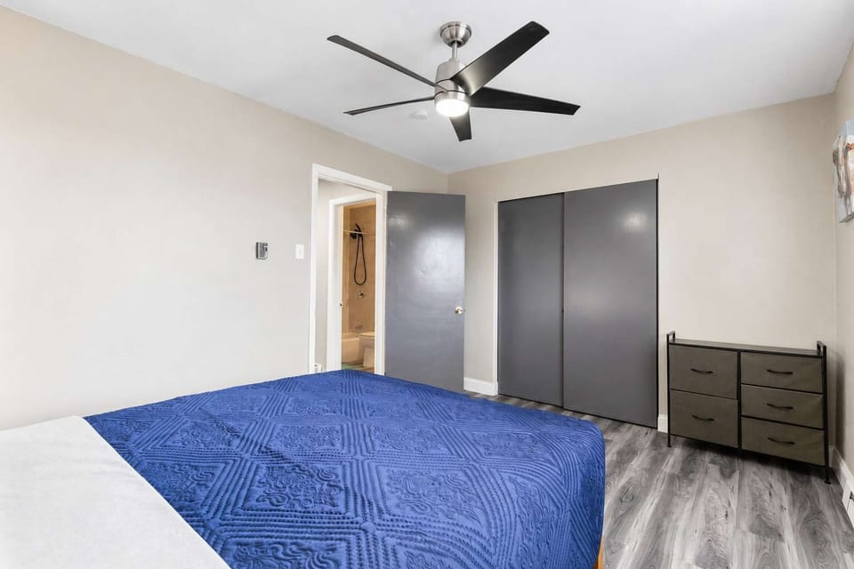 Queen bedroom — ceiling fan and closet storage for longer stays