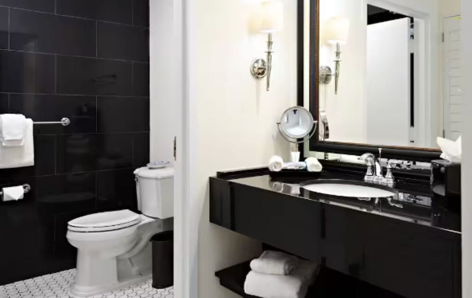 Refresh in a sleek bathroom with bright vanity lighting.