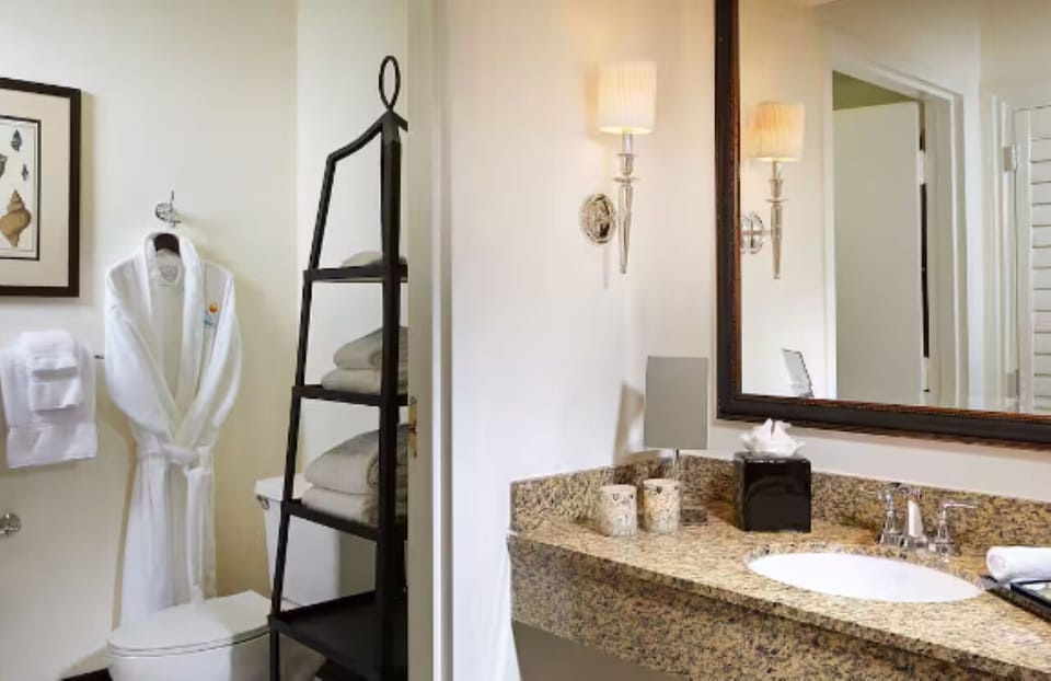 Refresh effortlessly with plush robes, bright vanity, and fresh towels.