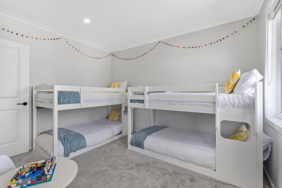 Fun bunk room with four single beds—perfect for kids or group stays.
