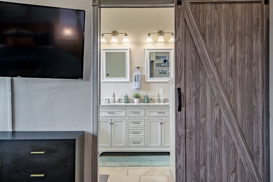 Bathroom: Start your mornings in a bright, modern sanctuary designed for two.