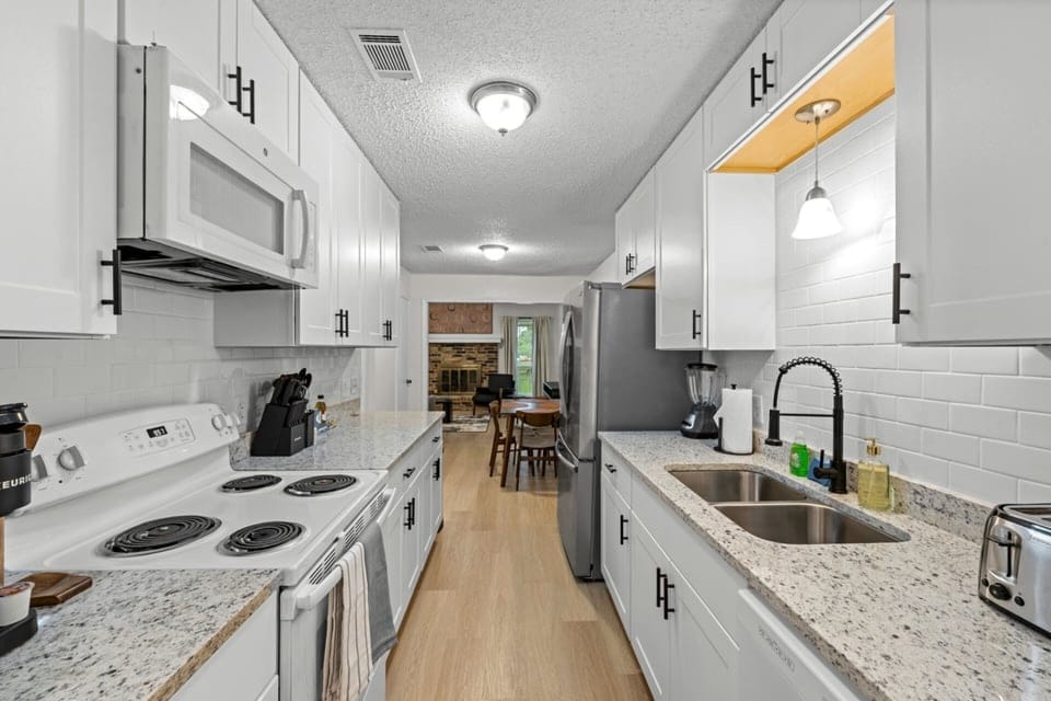 A bright, streamlined kitchen that makes it easy to prep meals, grab a quick bite, or keep snacks ready for game day.