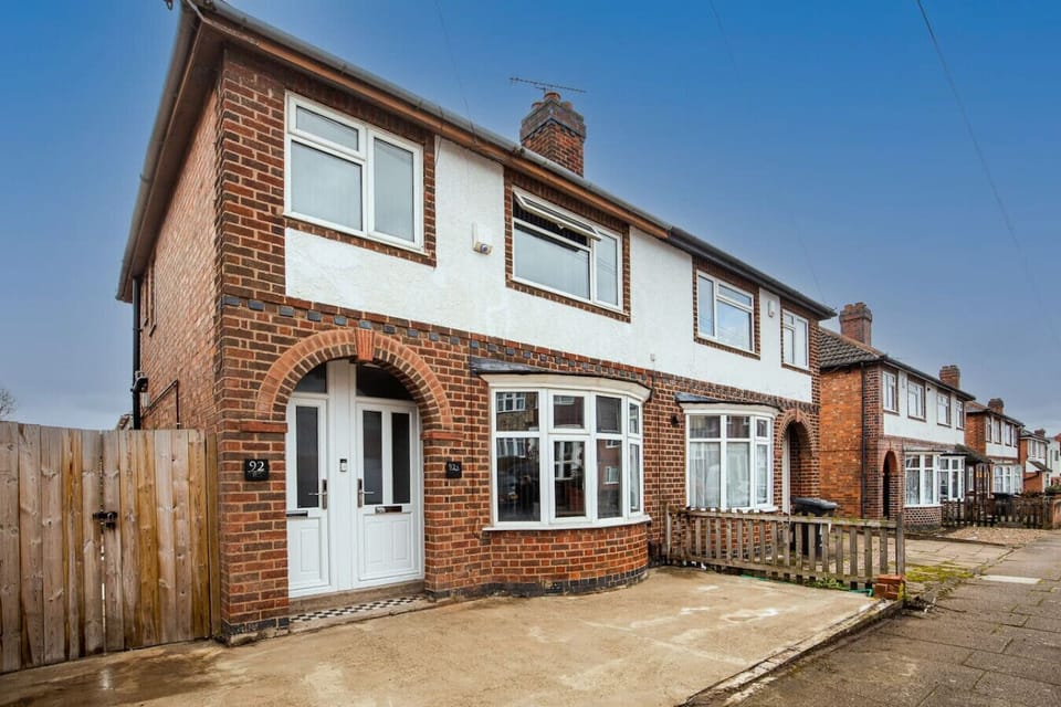 Classic brick semi with private off-street parking right at the door.