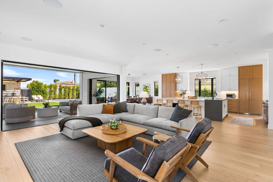 Gather and unwind in this sleek, open‑concept living area with direct access to the backyard oasis.