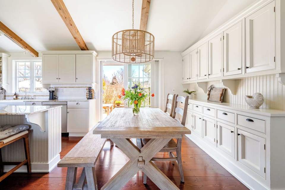 The dining table plus kitchen island offers plenty of seating for families.