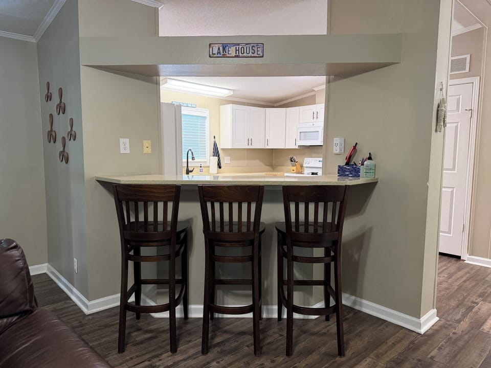 Open flow from the living room to the kitchen with barstool seating. 