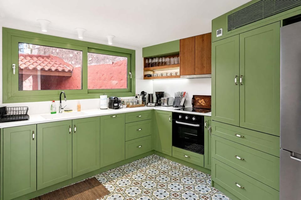 Large kitchen workspace with sleek countertops, outside views, and all the essentials for preparing meals with ease