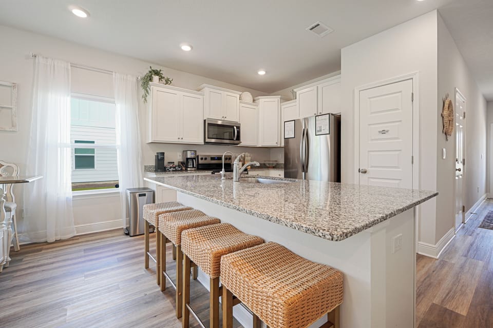 Your spacious kitchen features granite counters, stainless appliances, and comfortable seating where you can gather for meals and conversations.