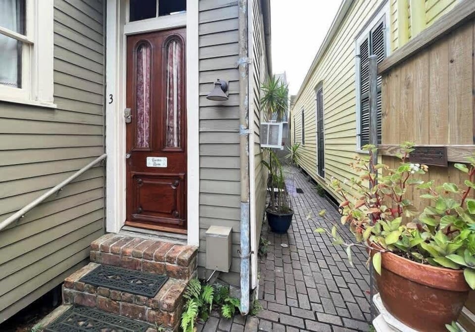 Exterior walkway leading to the entrance, adding a quiet and tucked-away feel.