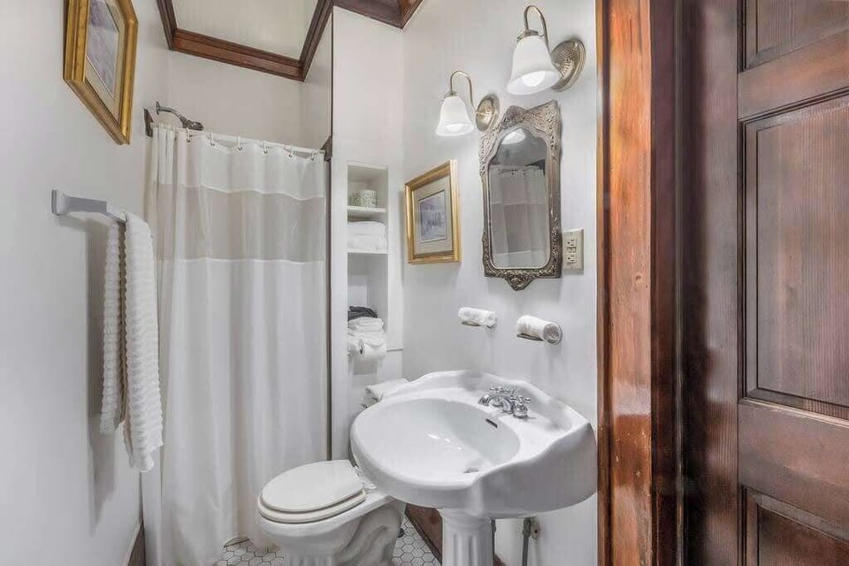 Full bathroom with vanity and a shower behind the curtain, offering a clean and functional setup.