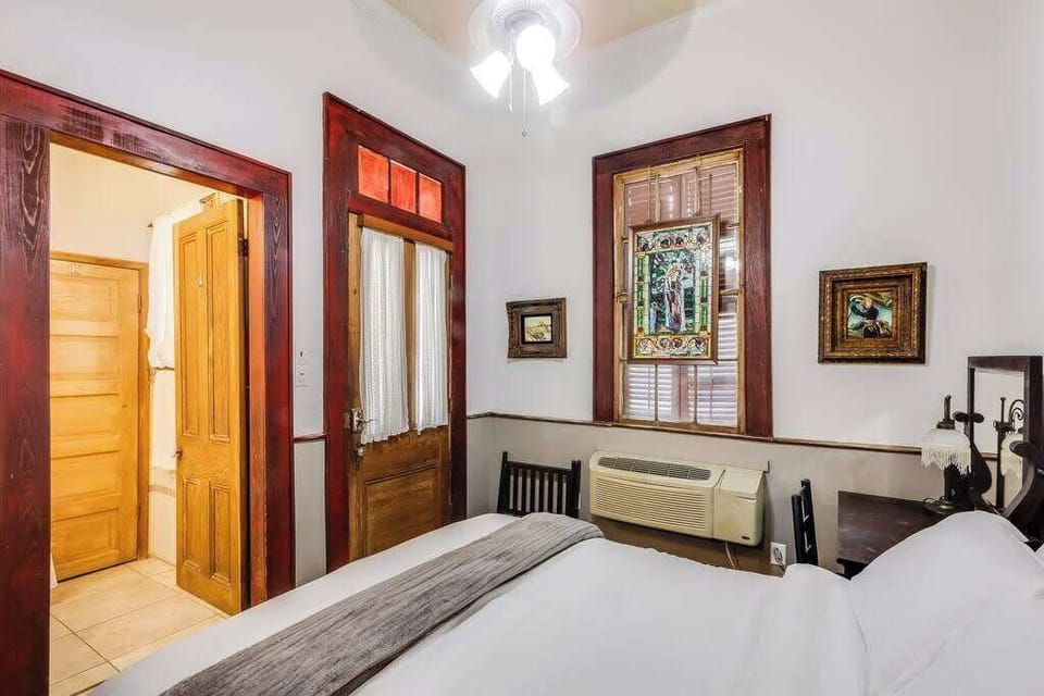 Another view of the bedroom showcasing spacious layout and traditional design elements.