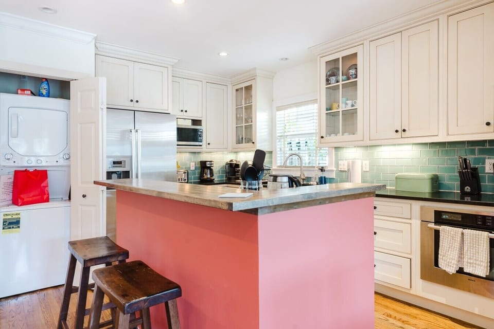 Tucked just off the kitchen, the stacked washer and dryer are easily accessible