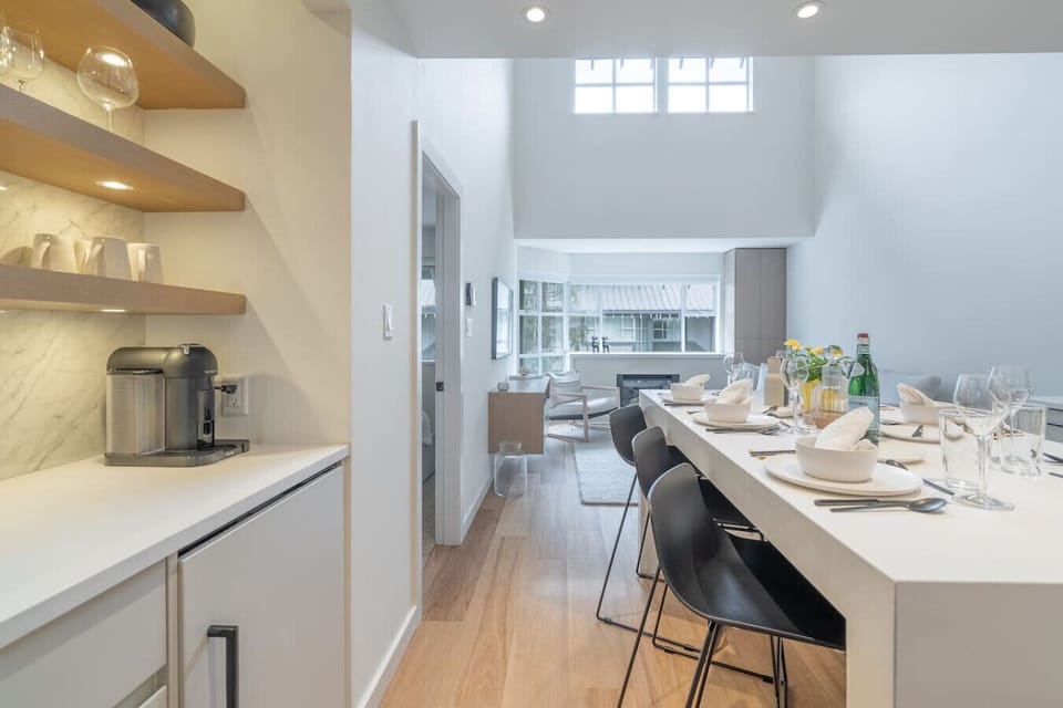 Discover our versatile coffee station equipped with a built-in wine fridge. Enjoy Nespresso, drip, and French press options. We provide a selection of organic ground coffee and Nespresso pods for your brewing pleasure.