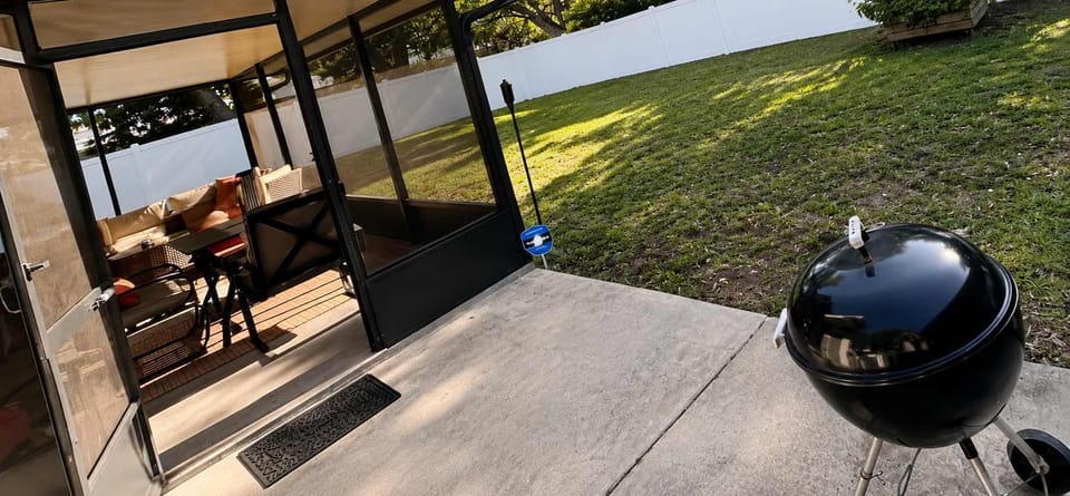 Enjoy a relaxing and comfortable outdoor experience in our private screened-in backyard patio — the perfect space to unwind morning or night. The backyard features a spacious covered lanai with comfortable seating, cozy décor, and a dining area ideal
