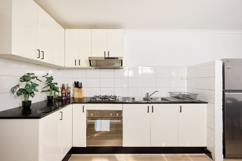 Our contemporary kitchen combines functional design with a clean, high-contrast aesthetic.