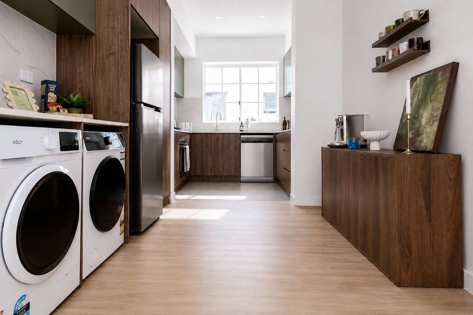Spacious galley-style kitchen with ample storage, full-size appliances, and integrated laundry facilities. Designed for longer stays with plenty of room for cooking, dining preparation, and everyday convenience.